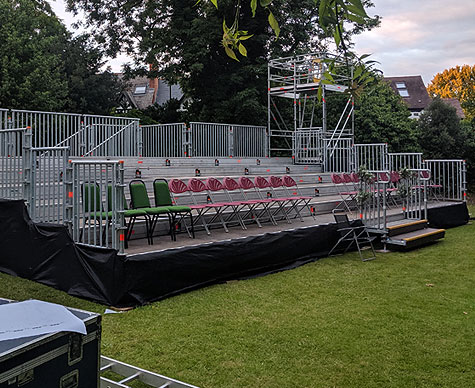 Outdoor tiered seating with camera towers.